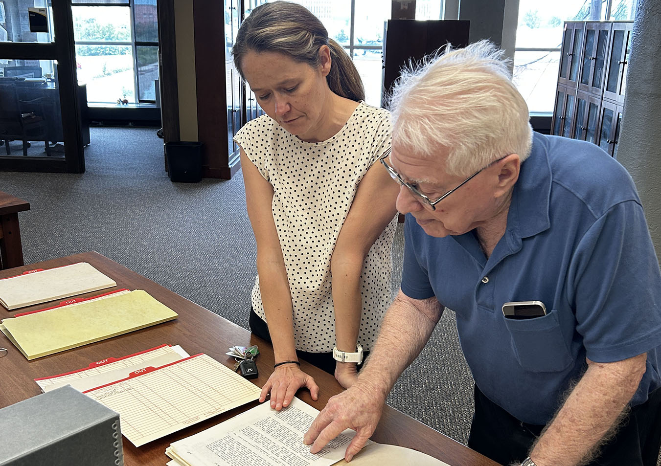 Visitors looking at archival documents
